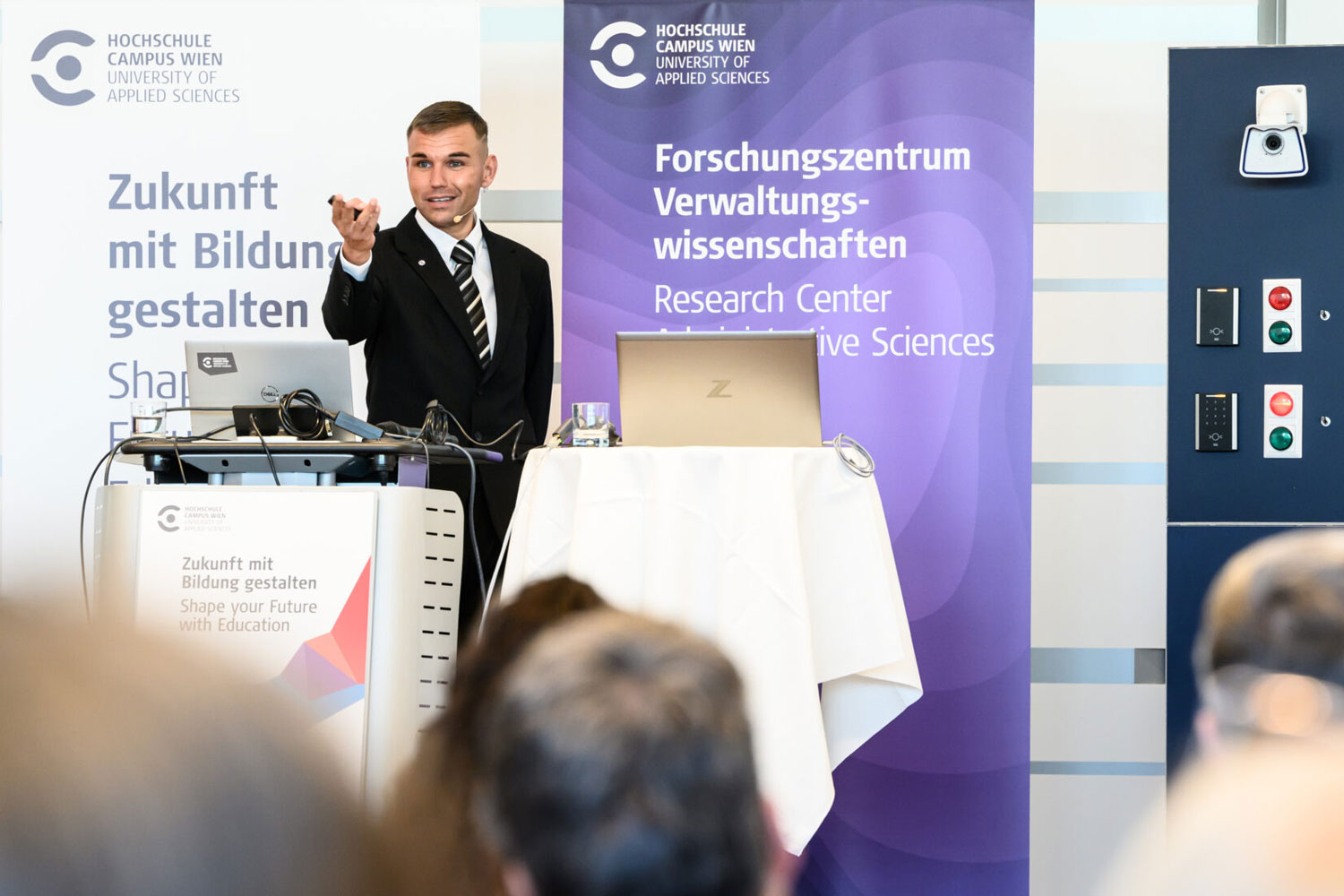 Lehrender und Forschender Marlon Possard steht auf dem Podium und hält einen Vortrag